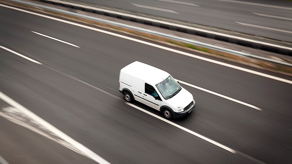 Delivery white van moving highway road