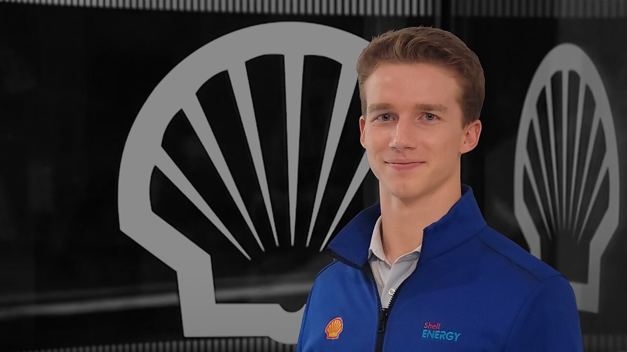Young man posing in front of Shell logo