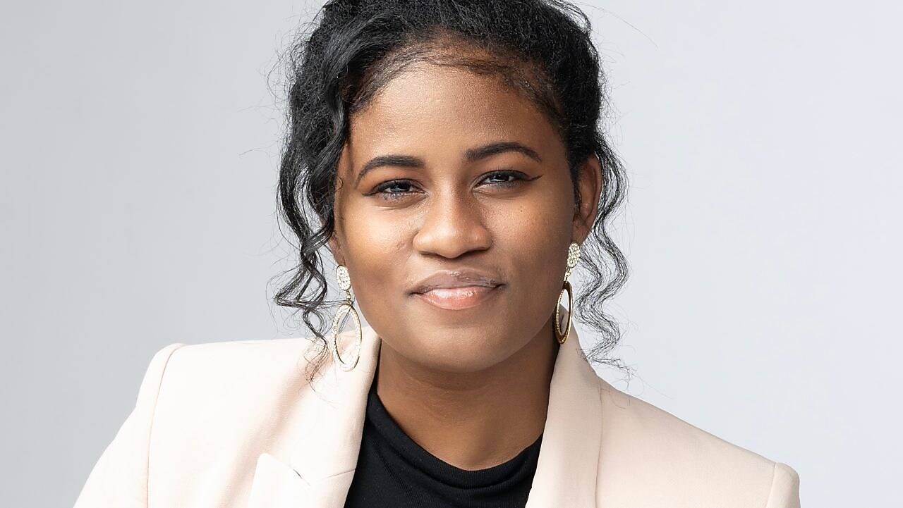 professional headshot of a woman wearing a beige jacket