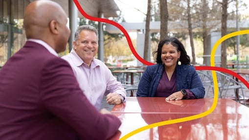 Three people chatting and smiling