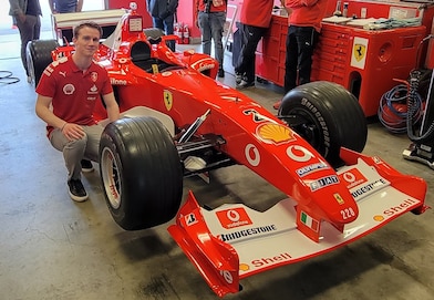 Young man posing in front of Shell logo