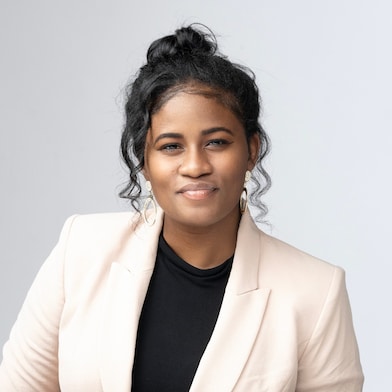 professional headshot of a woman wearing a beige jacket