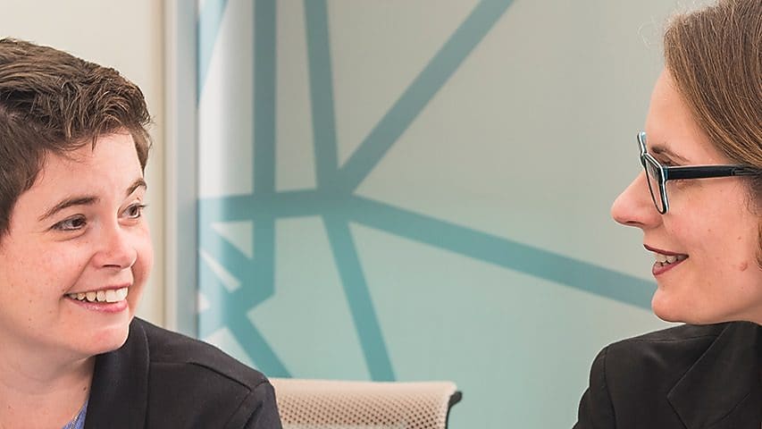 two women smiling at each other