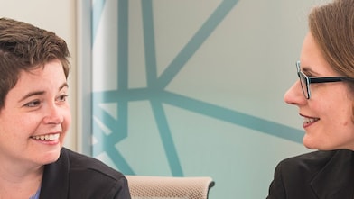 two women smiling at each other