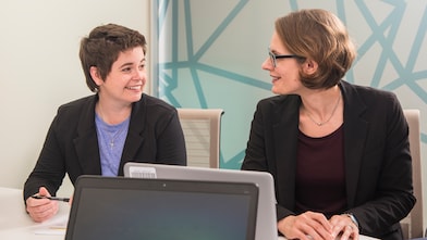 two women smiling at each other