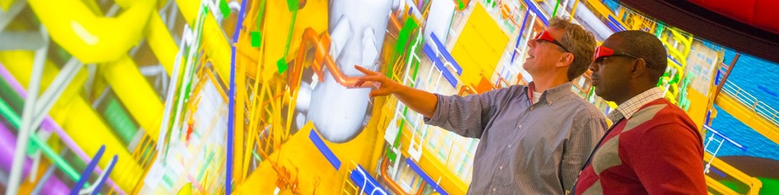 Two Shell employees with 3D glasses looking at an interactive map