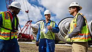 Shell engineers meeting at an operational site.