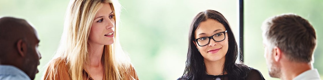 A female experienced professional at Shell smiling during a meeting.