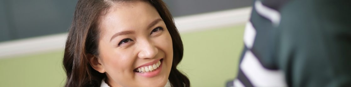 A young Shell female employee smiling.