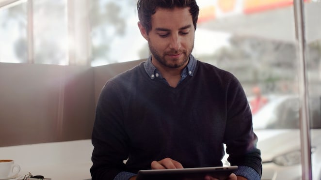 a man busy with tablet holded on his hand