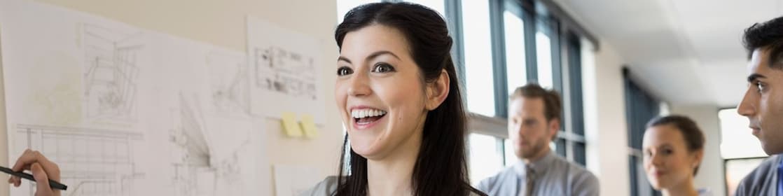 Woman smiling in front of colleagues