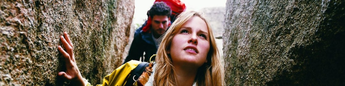 Two People Orienteering Between Rocks