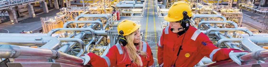 Two shell employees talking at work site