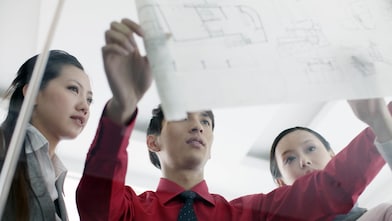 man showing bluprint to colleagues