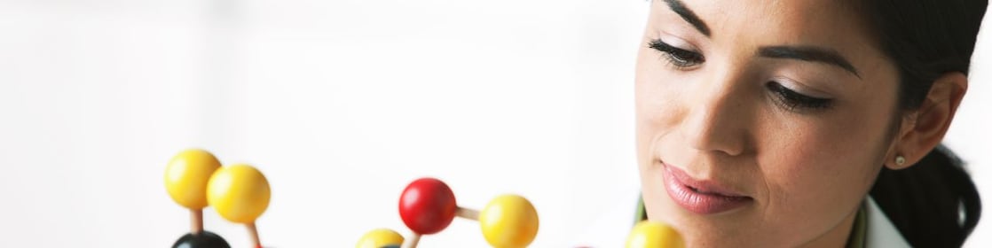 scientist looking at molecule model