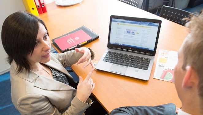 Women discussing project details with Man