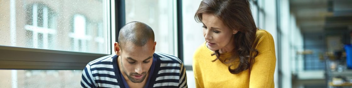 Two architects discussing project at high table