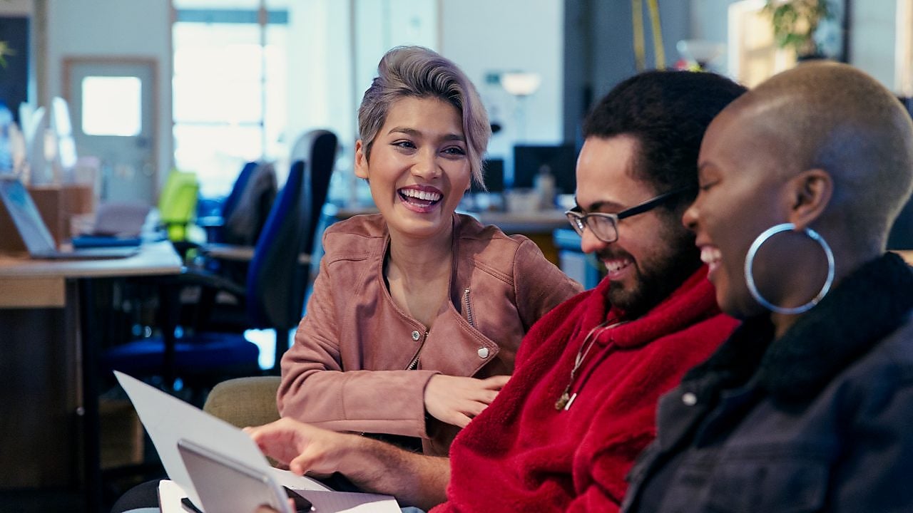 Laughing creative business people working in office