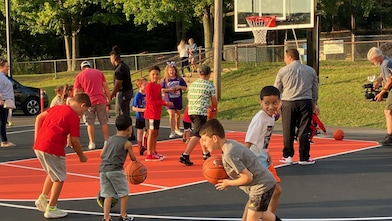 children playing basketball on court