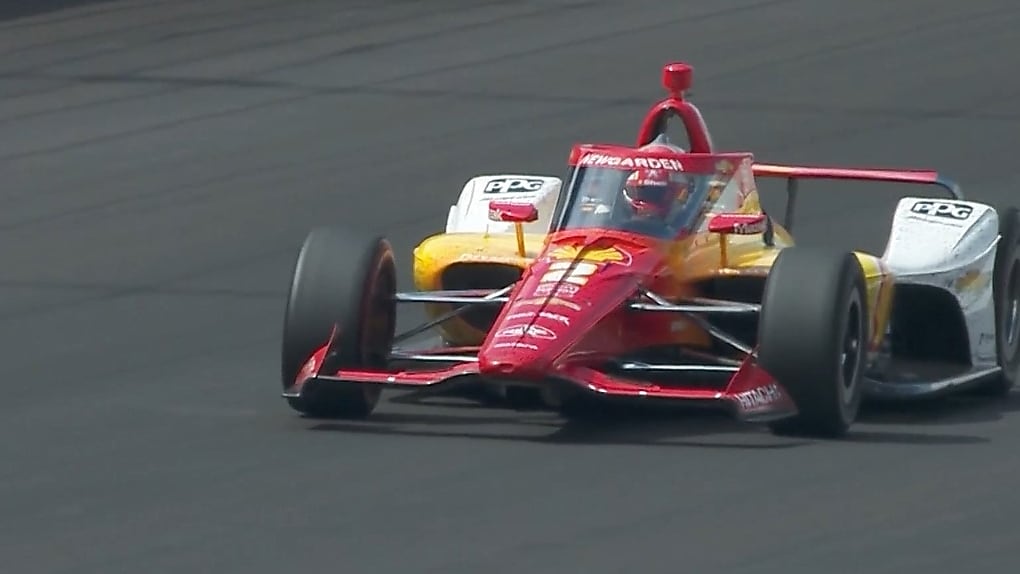A Penske Indy Car in the pit shot from overhead, being filled with Shell Renewable Racefuel