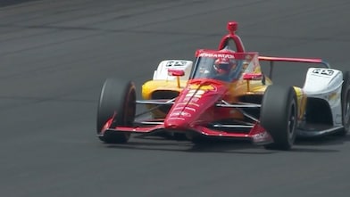A Penske Indy Car in the pit shot from overhead, being filled with Shell Renewable Racefuel