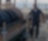 A man stands in protective gear next to a refining unit