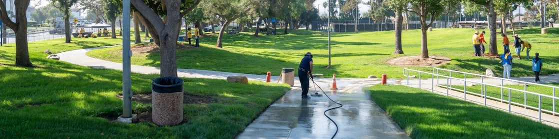 person washing the sideway of a park