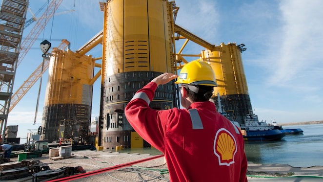 A Shell worker inspects the Olympus hull