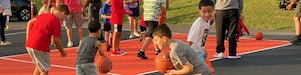 children playing basketball on court