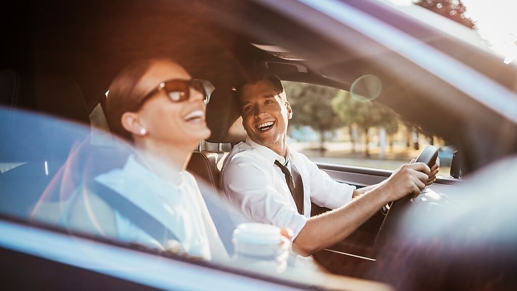 Man driving with a woman passenger