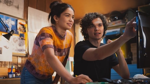 Young woman and a man watching digital printer