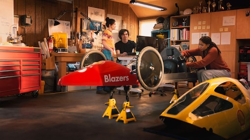Two young women and a young man working on a prototype vehicle for Shell Eco-marathon