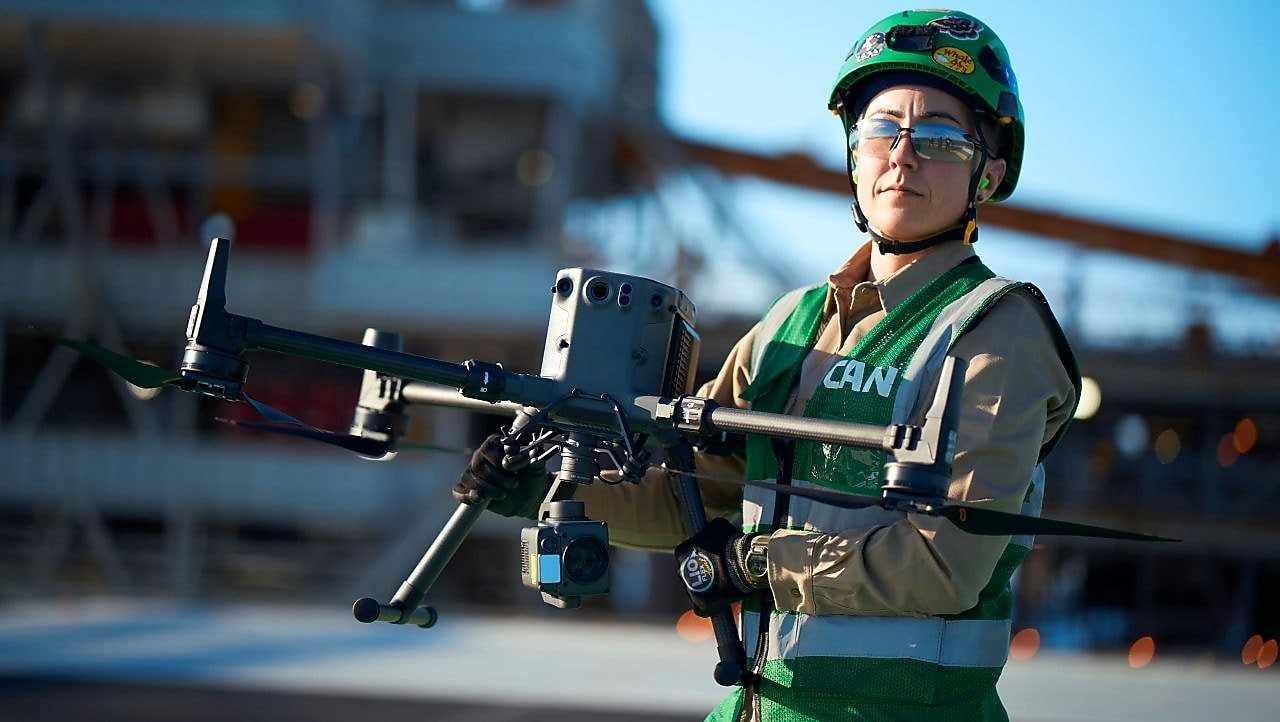 Woman carrying a large drone