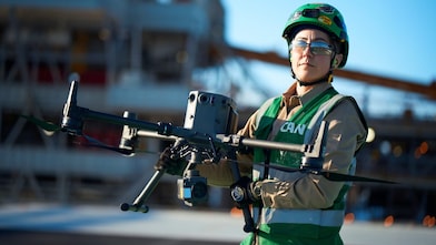 Woman carrying a large drone