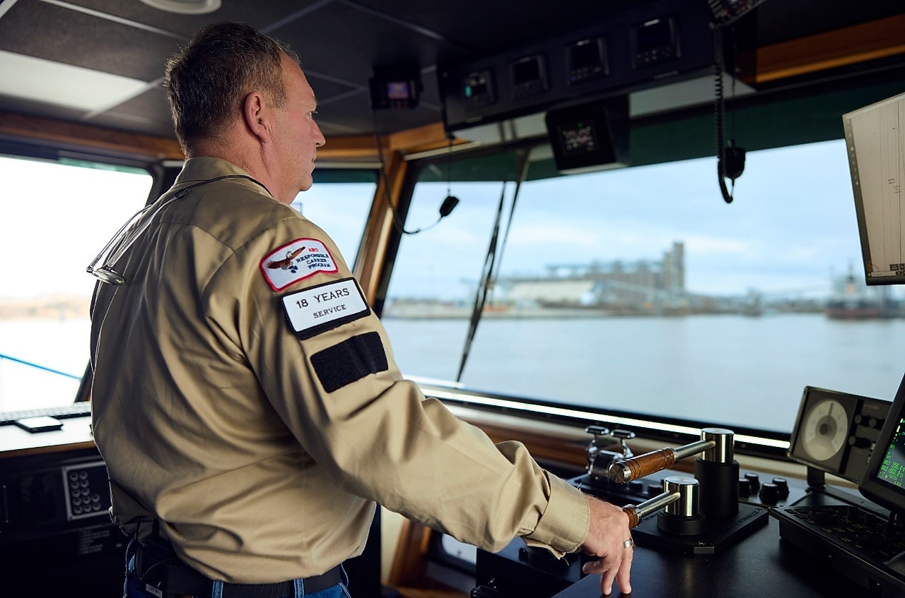 Man steering a towboat