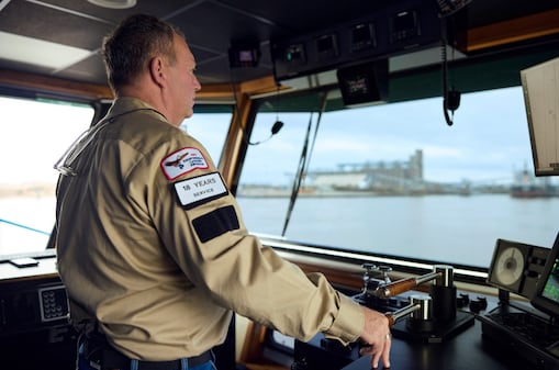 Man steering a towboat