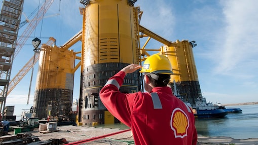A Shell worker inspects the Olympus hull