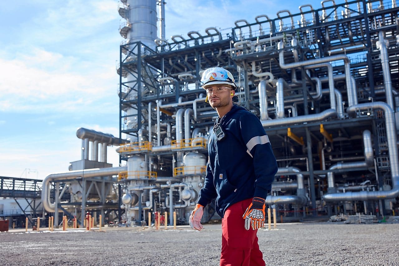 Man in front of manufacturing complex
