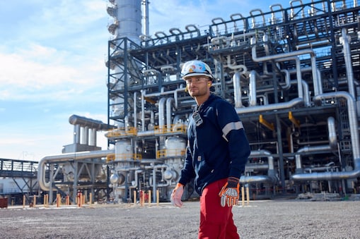 Man in front of manufacturing complex