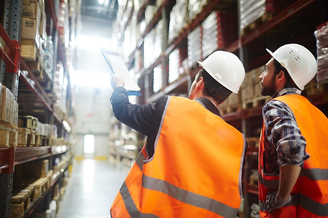 Worker inspecting a large warehouse