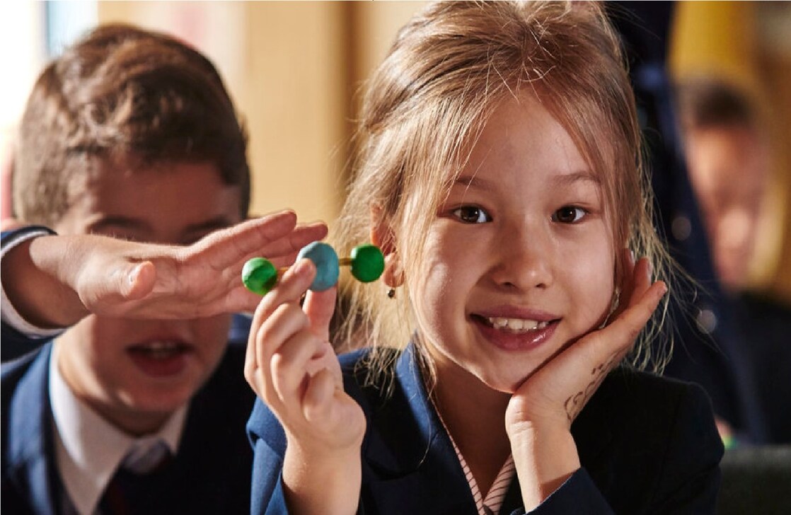 School girl holding her science project