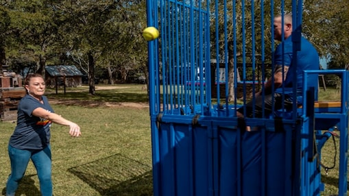Shell Deer Park employee throws ball at team leader in dunk tank.