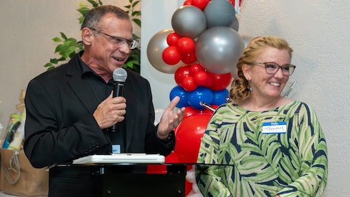 United Way of St Charles Executive Director John Dias presents Shell Norco VP Tammy Little with an award