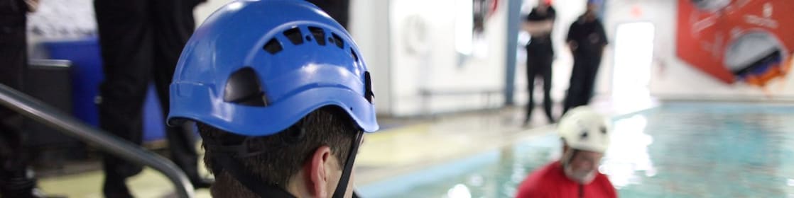 A man enters a pool for training
