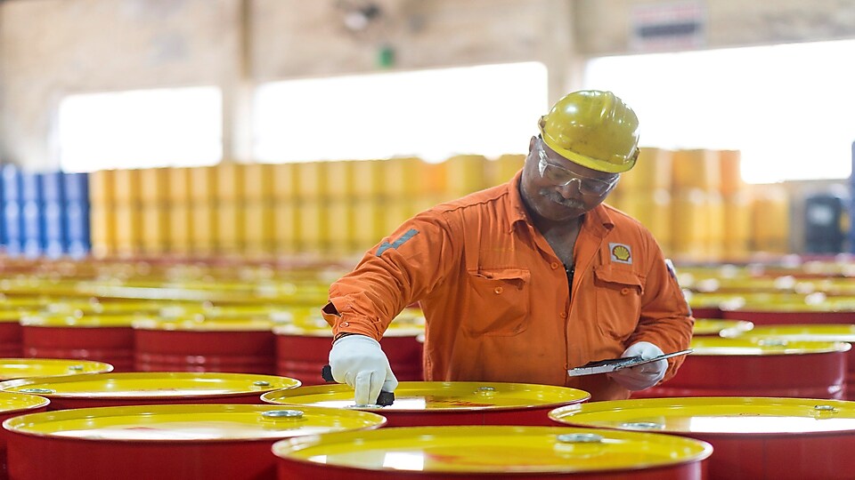 Shell employee inspecting lubricants