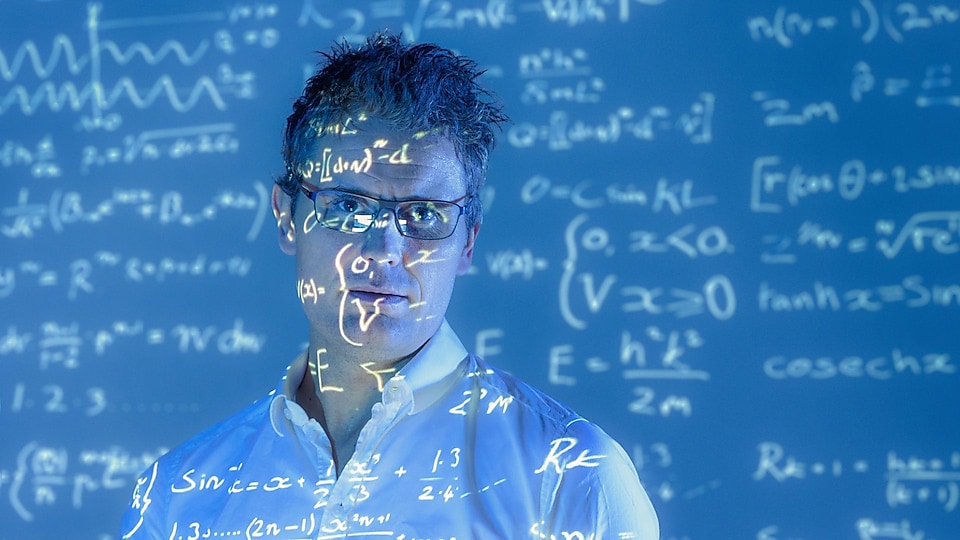 Scientific formulae projected on to face of scientist
