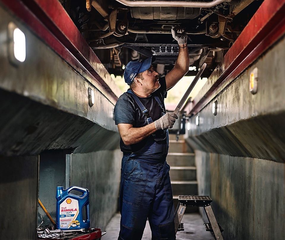 Man working on a truck part.