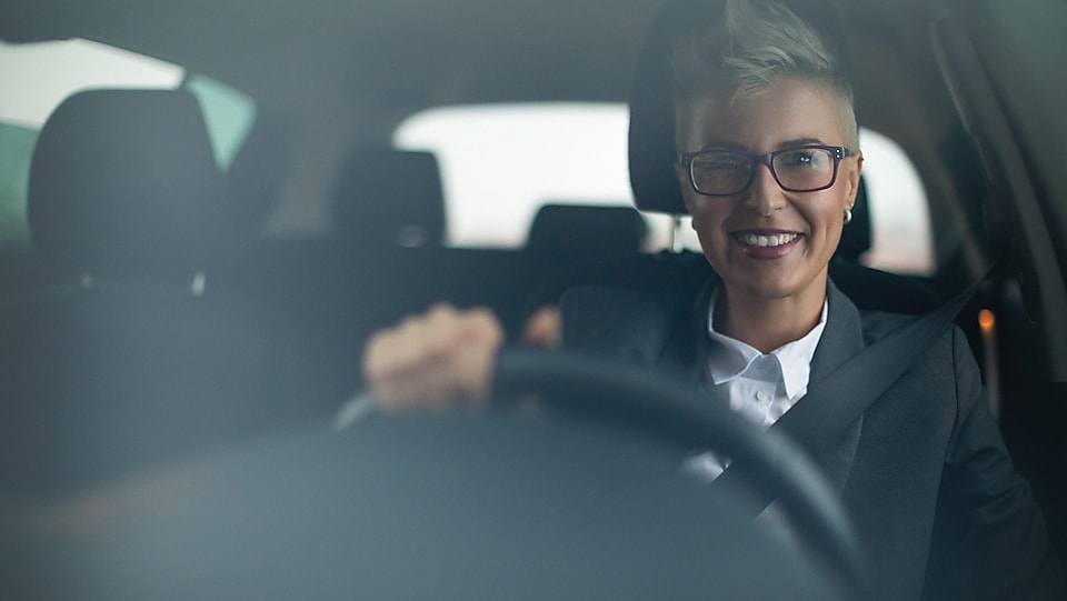 Man smiling and driving car