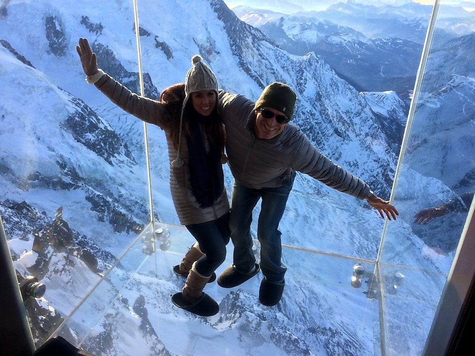 Elena and her husband on the glass floor above Mont Blanc in Switzerland