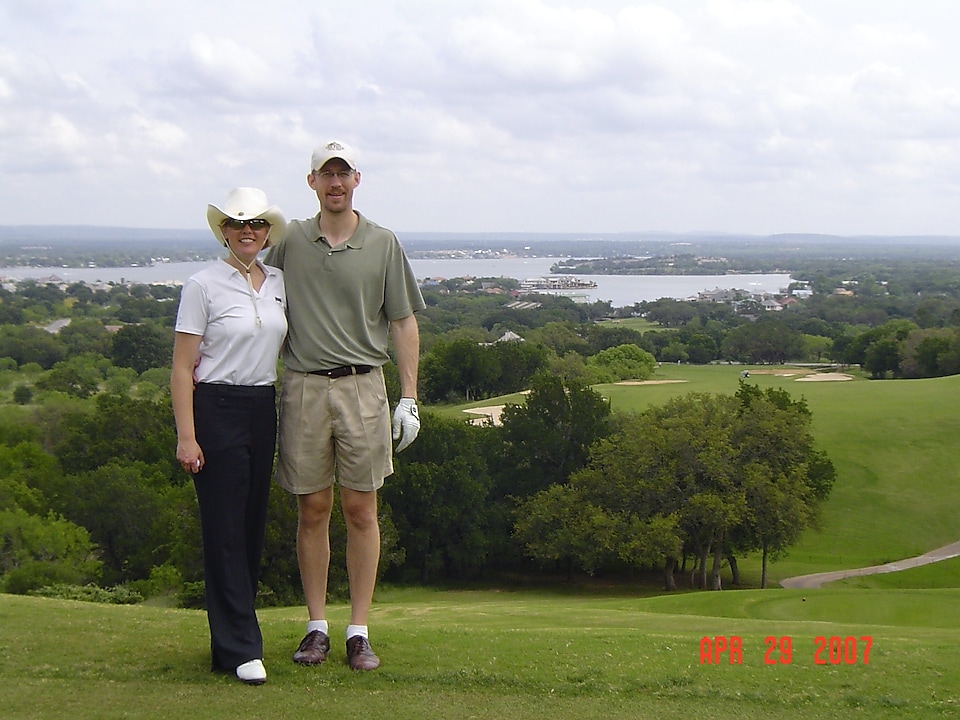 Kim with her husband on a golf course